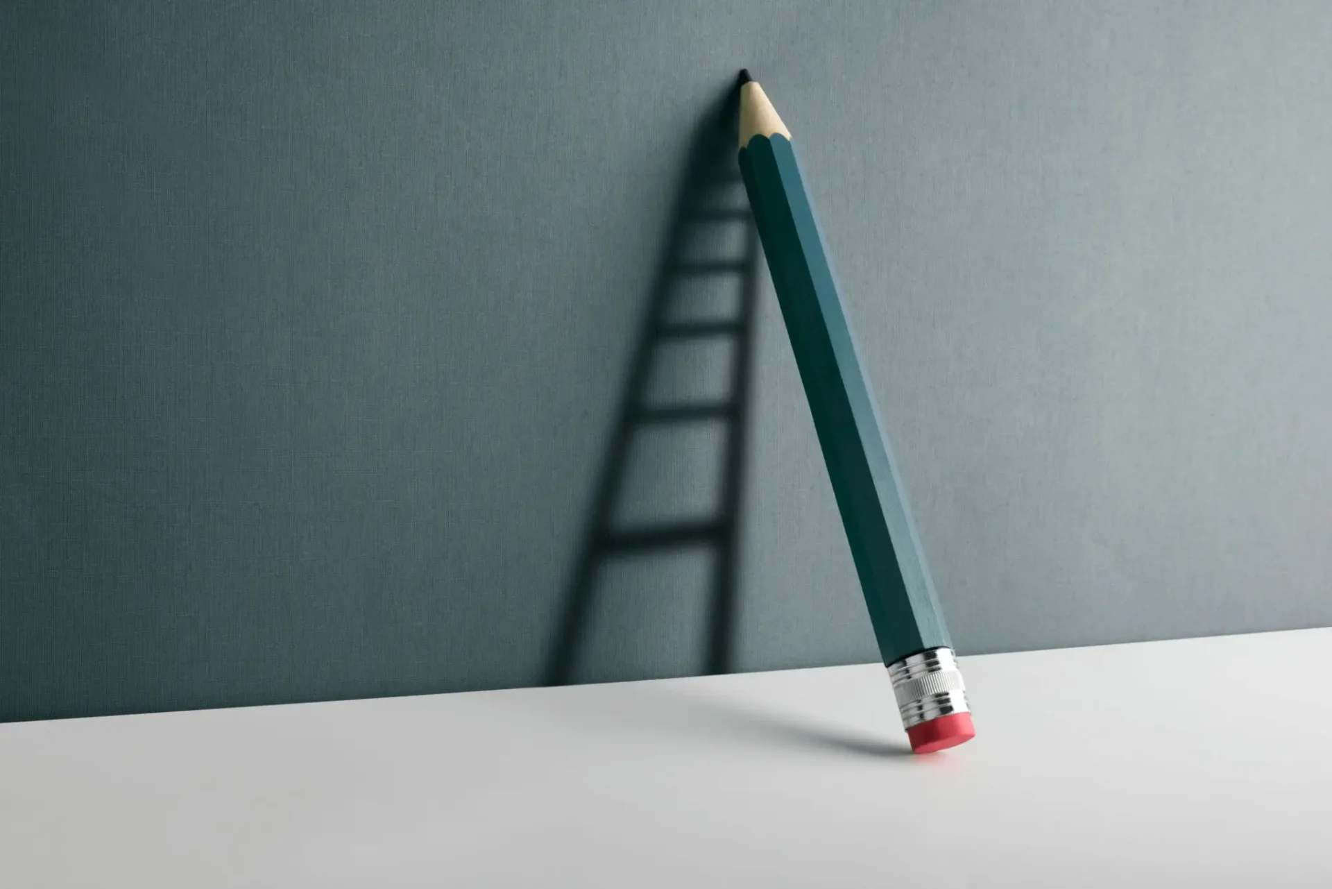 A pencil casting a shadow shaped like a ladder on a wall.