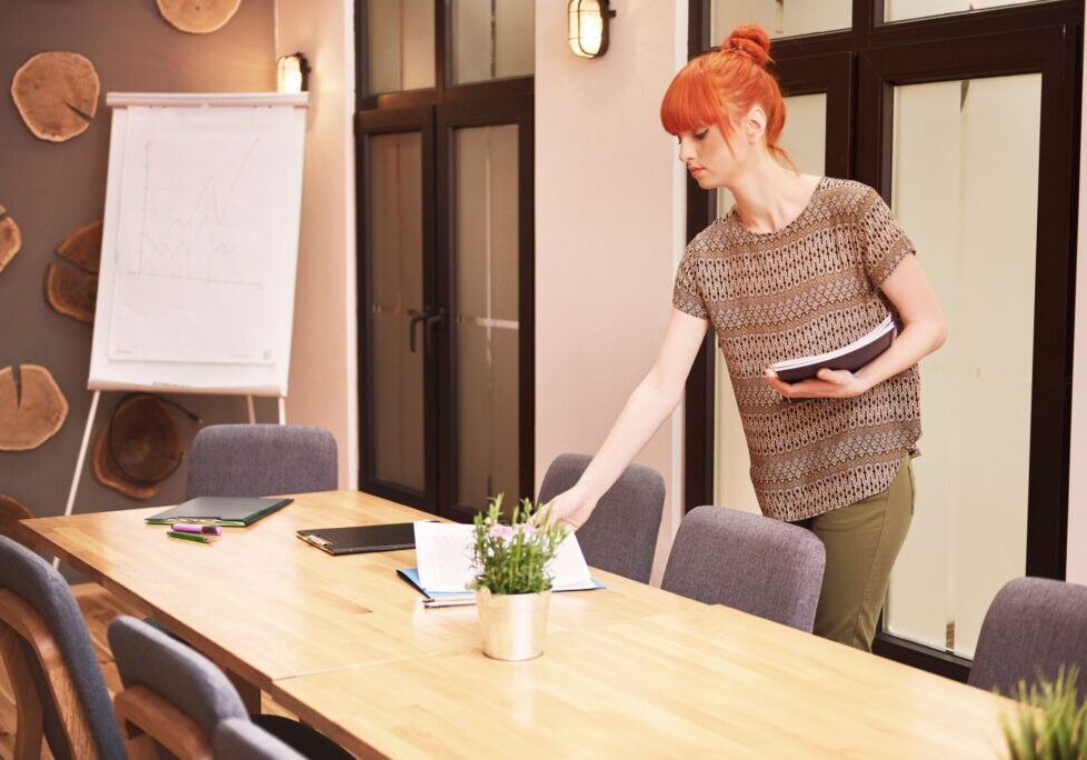 Red-haired woman arranging meeting documents