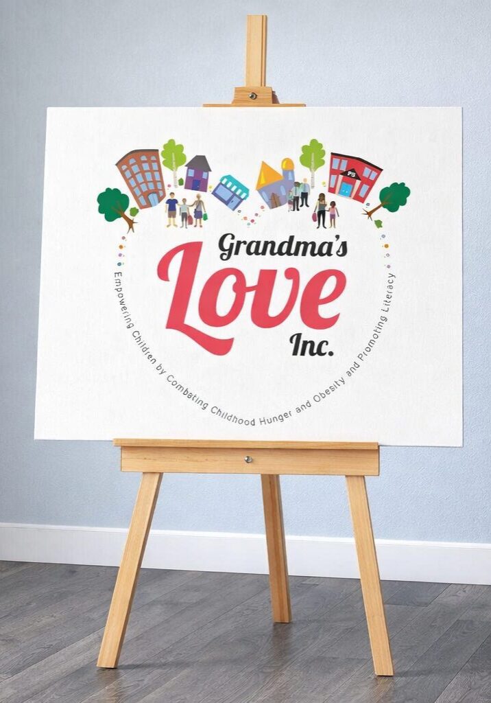 Decorative sign with 'Grandma's Love Inc.' in a heart shape on an easel.
